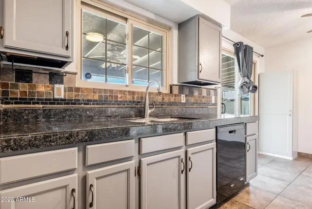 a kitchen with a sink and cabinets