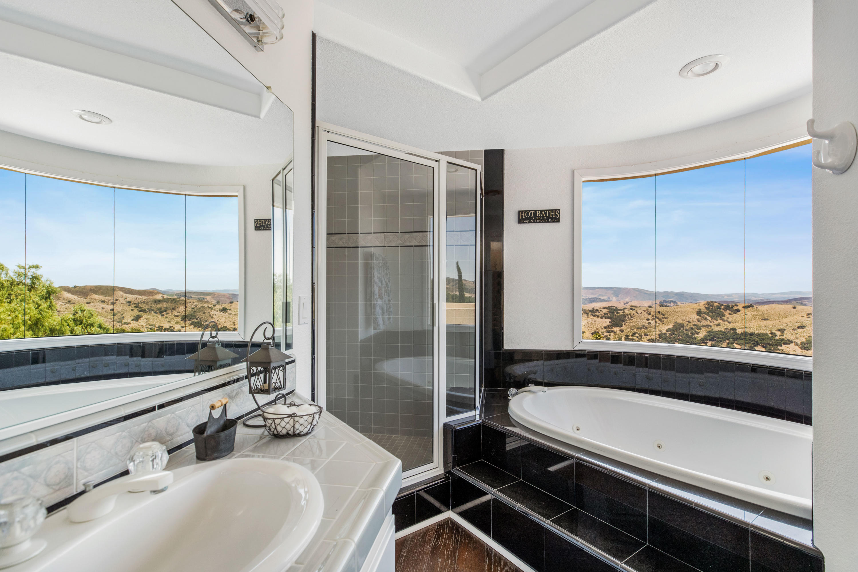 1833 Cougar Ridge Road Buellton, CA 93427 - Photo 22 of 49 a bathroom with a sink and a large mirror