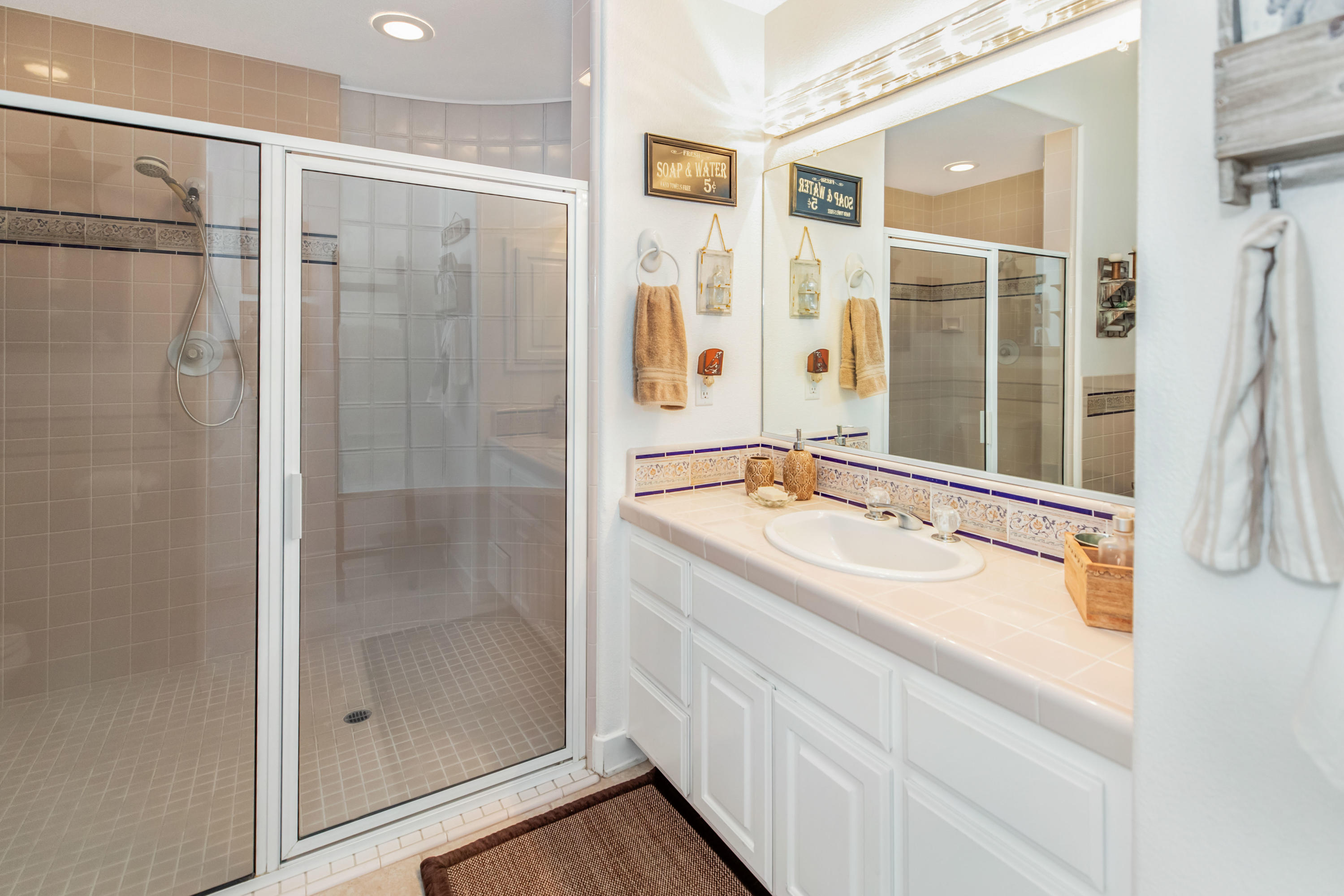 1833 Cougar Ridge Road Buellton, CA 93427 - Photo 23 of 49 a bathroom with a shower sink and mirror