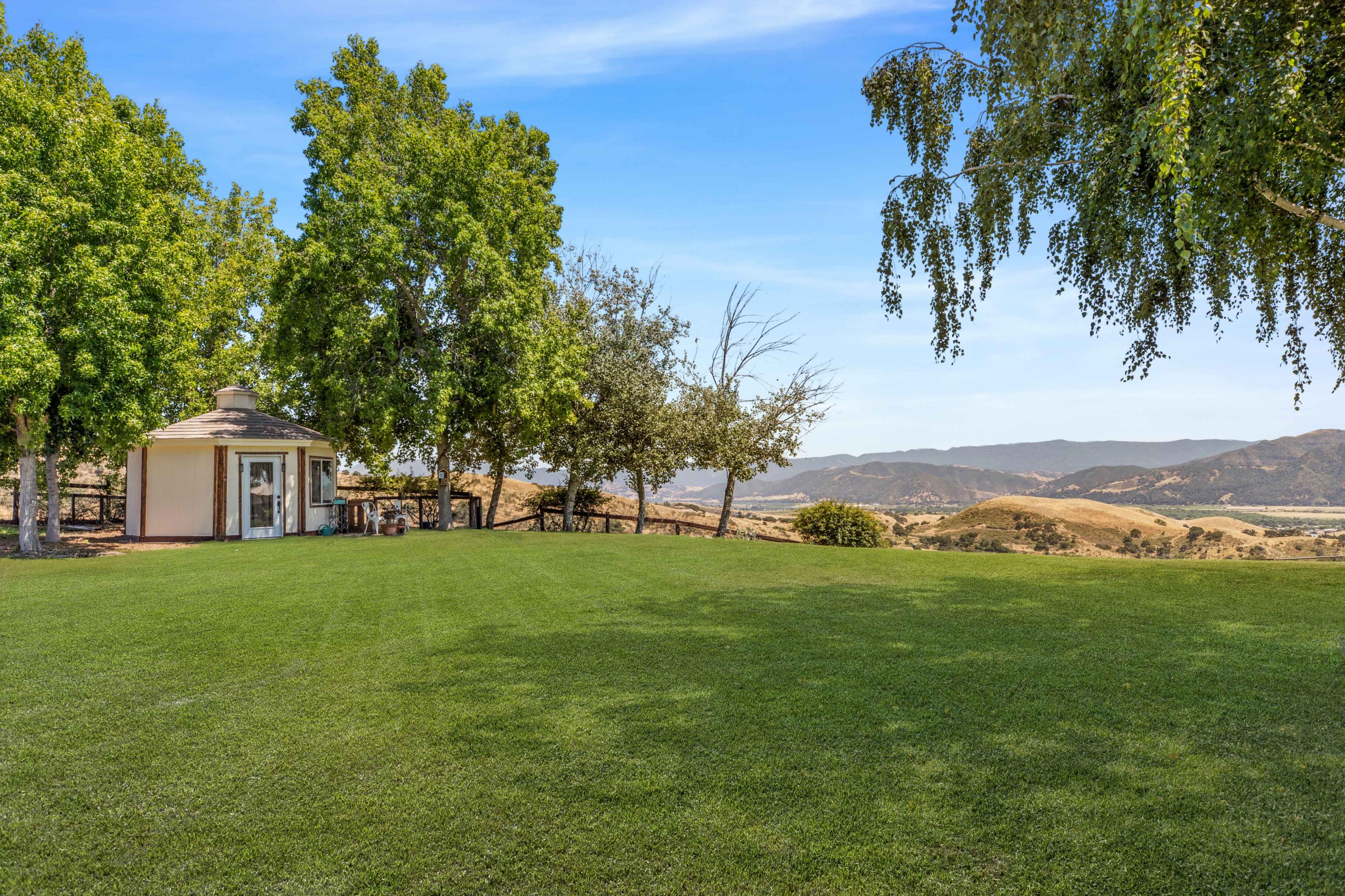 1833 Cougar Ridge Road Buellton, CA 93427 - Photo 36 of 49 a view of a big yard with a house in the background