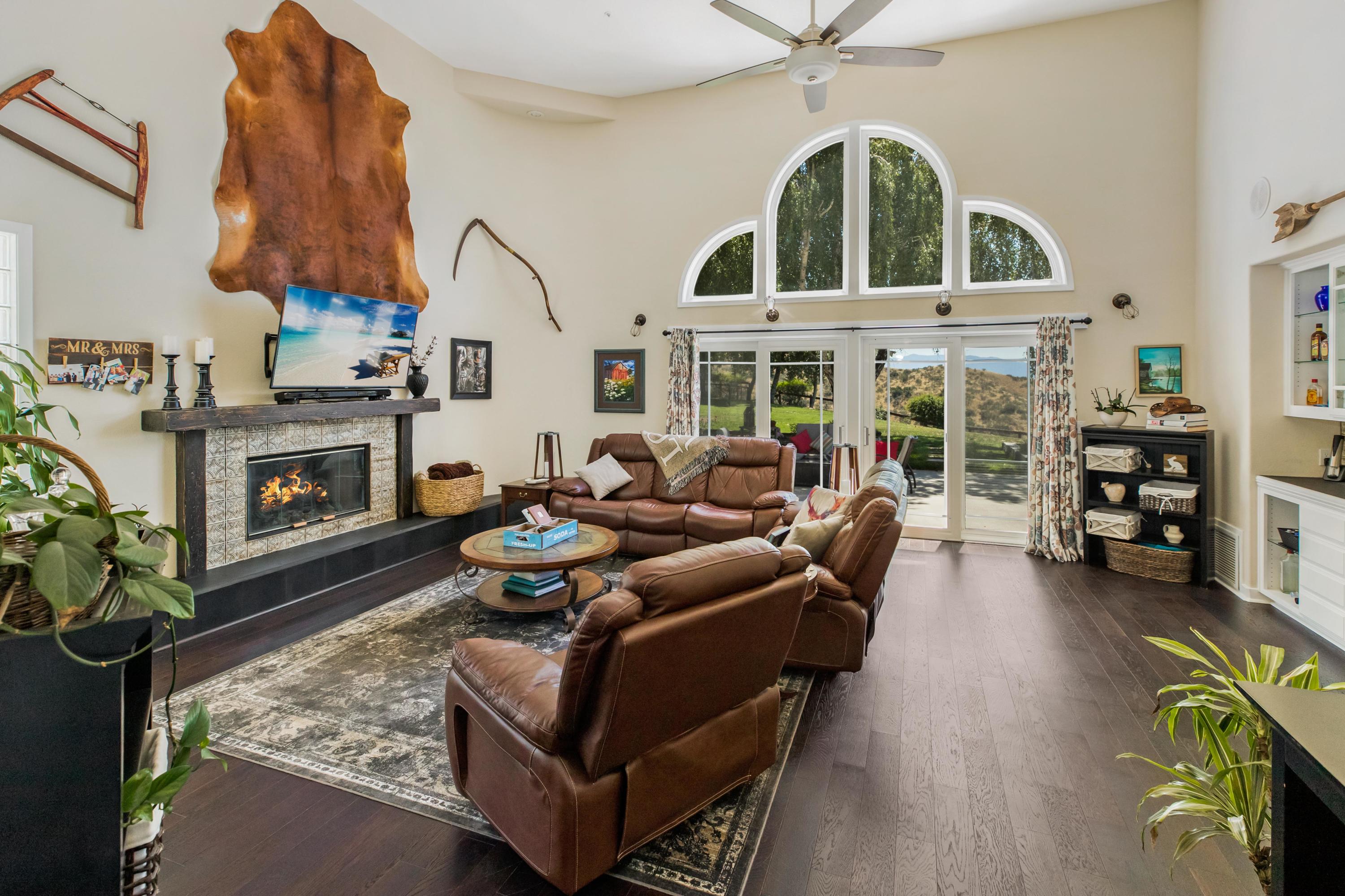 1833 Cougar Ridge Road Buellton, CA 93427 - Photo 4 of 49 a living room with furniture a fireplace and a chandelier