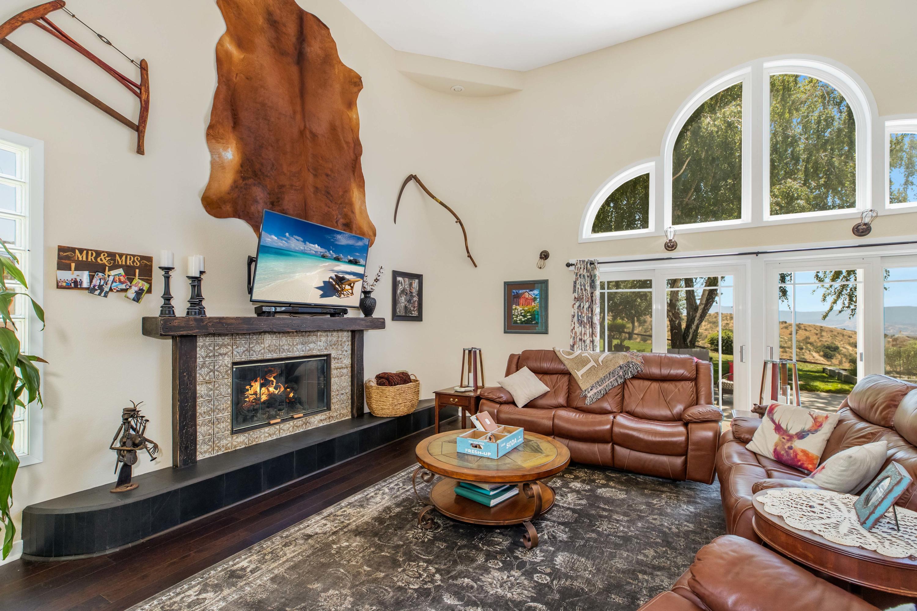 1833 Cougar Ridge Road Buellton, CA 93427 - Photo 5 of 49 a living room with furniture fireplace and a large window
