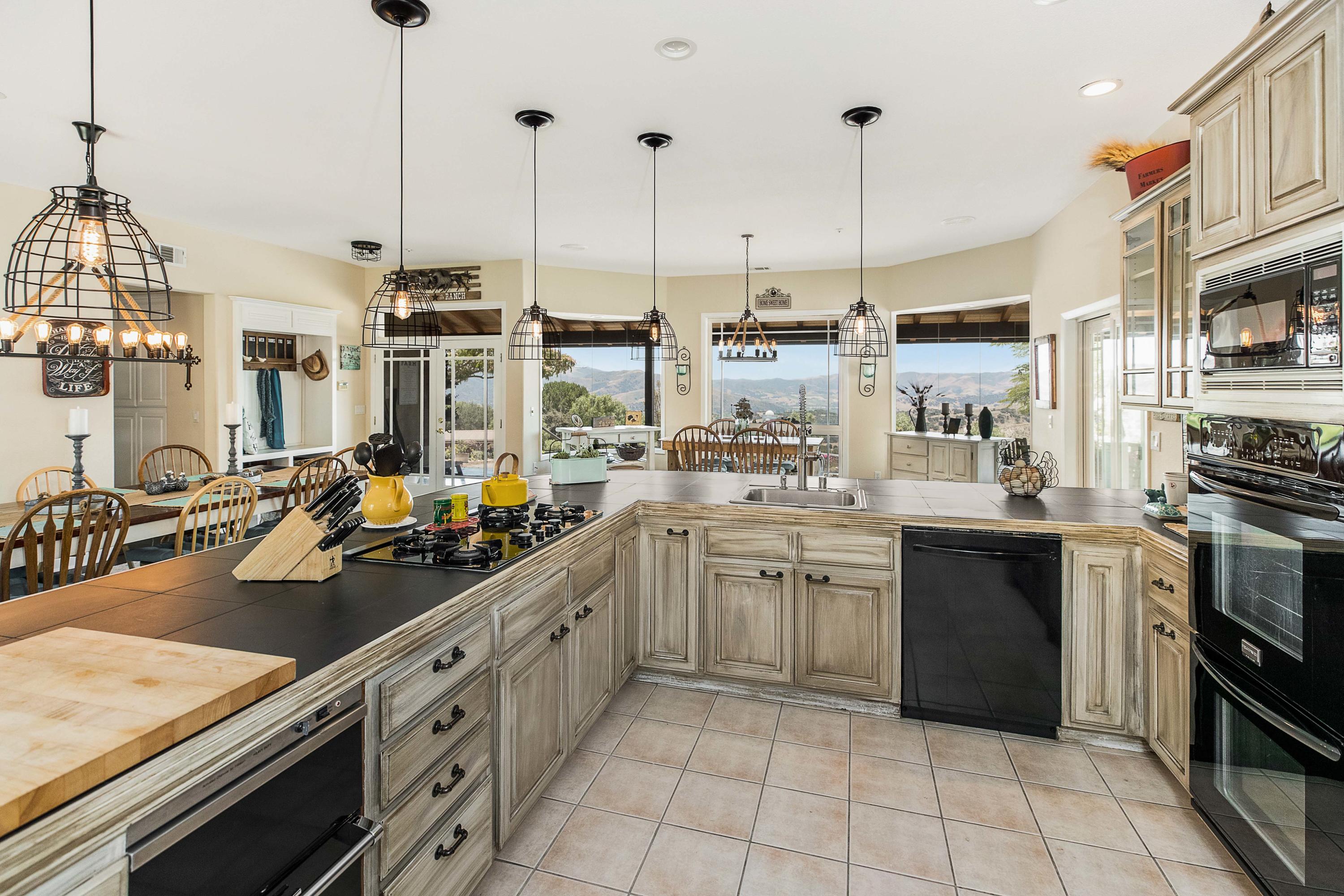 1833 Cougar Ridge Road Buellton, CA 93427 - Photo 7 of 49 a kitchen with stainless steel appliances granite countertop a sink a stove and a wooden floors