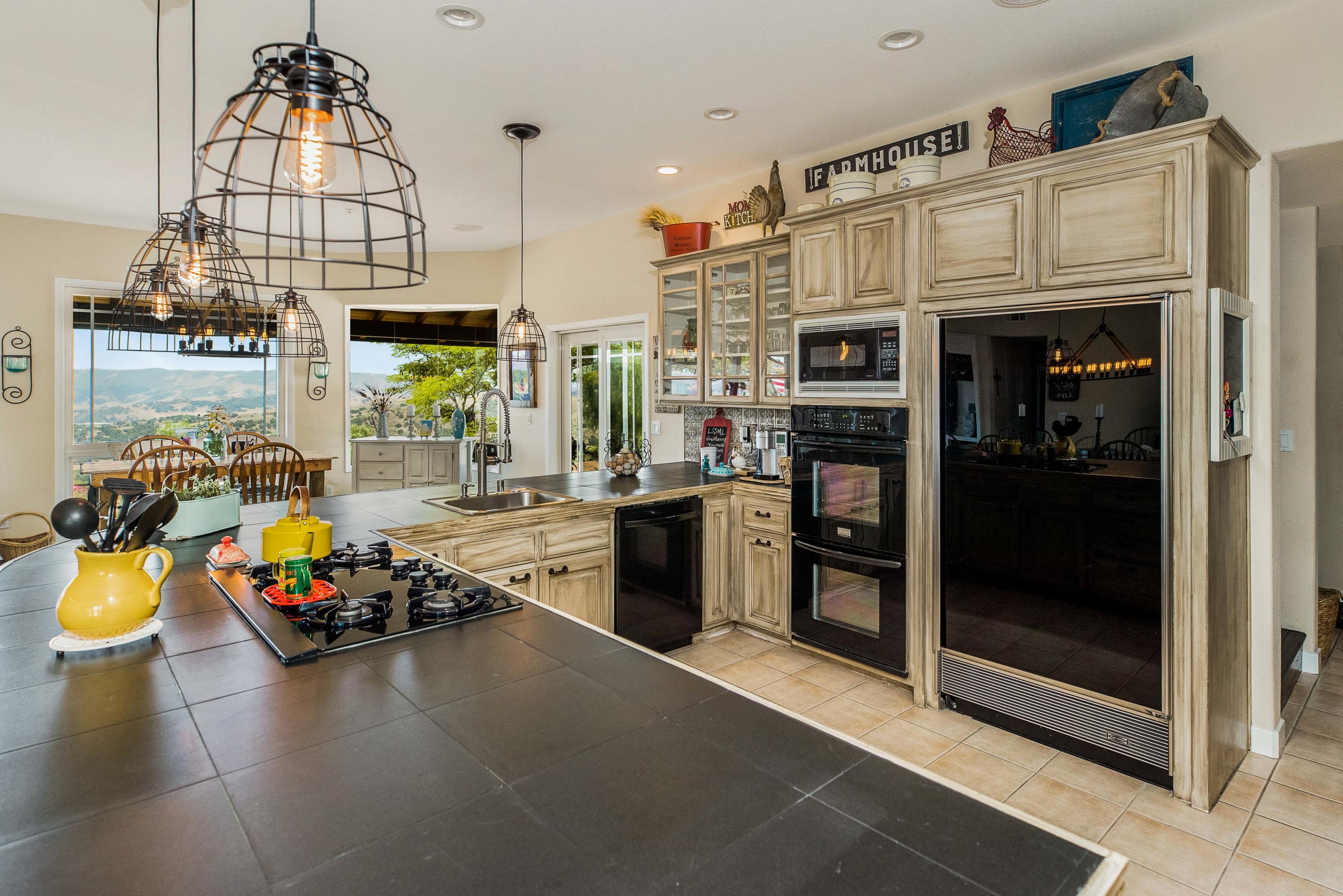 1833 Cougar Ridge Road Buellton, CA 93427 - Photo 9 of 49 a open kitchen with granite countertop a stove and a sink