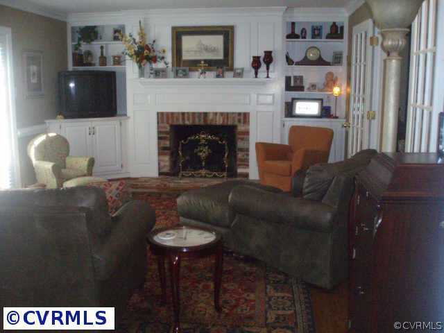 14310 West Salisbury Road Midlothian, VA 23113 - Photo 4 of 9 a living room with furniture a flat screen tv and a fireplace