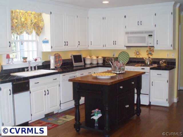 14310 West Salisbury Road Midlothian, VA 23113 - Photo 6 of 9 a kitchen with a sink and cabinets