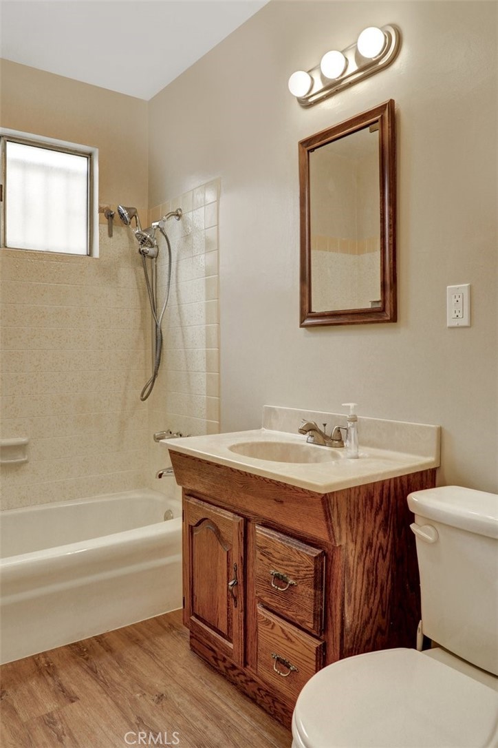 10661 Ilex Avenue Pacoima, CA 91331 - Photo 11 of 22 a bathroom with a granite countertop toilet sink and mirror