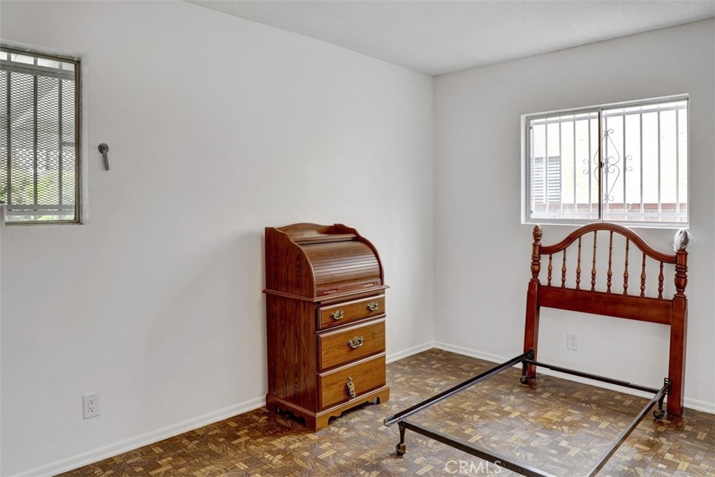 10661 Ilex Avenue Pacoima, CA 91331 - Photo 12 of 22 a view of a bedroom with furniture and windows