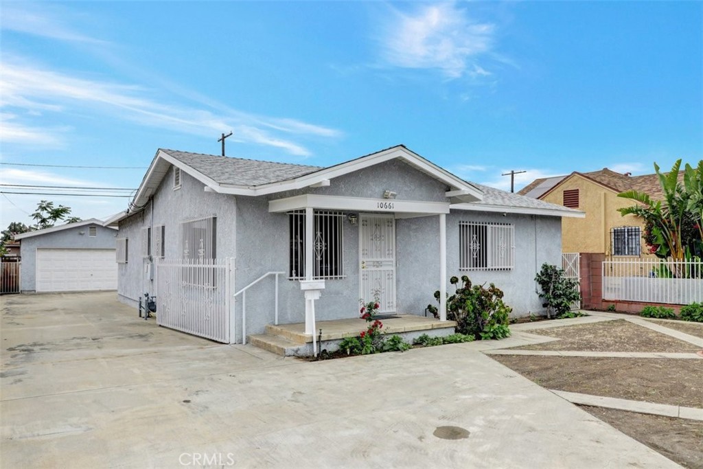 10661 Ilex Avenue Pacoima, CA 91331 - Photo 3 of 22 front view of a house with a yard