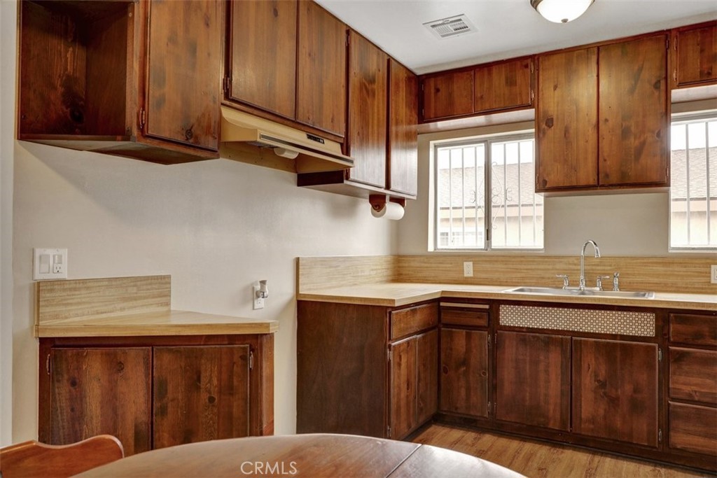 10661 Ilex Avenue Pacoima, CA 91331 - Photo 8 of 22 a kitchen with kitchen island granite countertop a sink window and cabinets