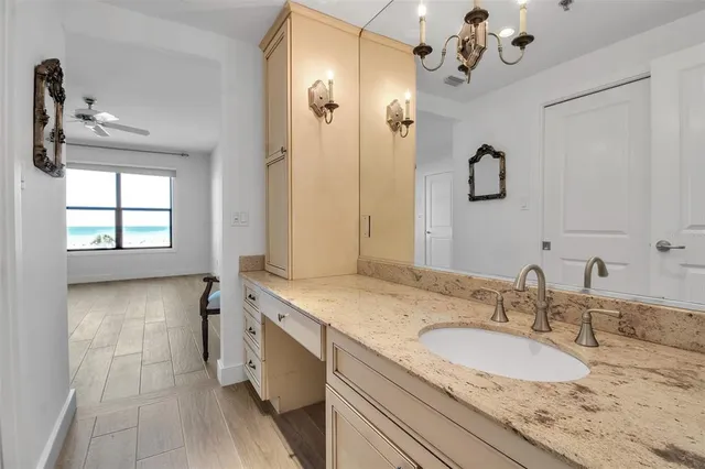 a bedroom with a large bed and a chandelier