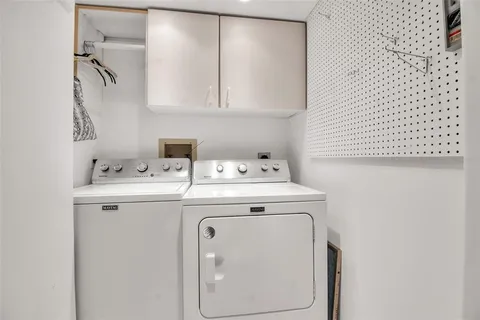 a view of swimming pool with outdoor seating and house in the background