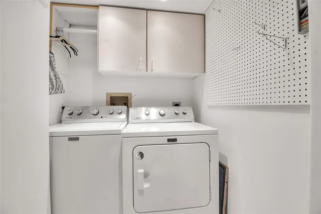 a view of swimming pool with outdoor seating and house in the background