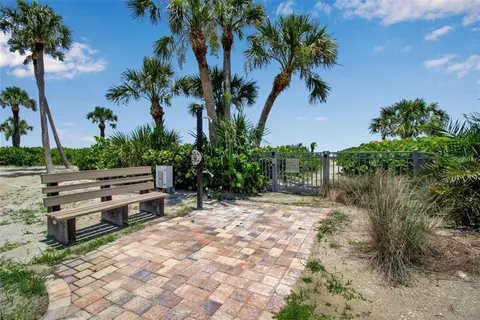 a view of a bench in patio next to a yard