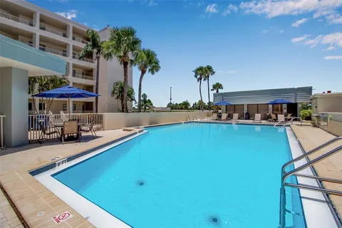 a view of a patio with a table and chairs under an umbrella