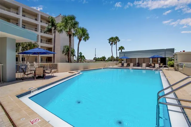 a view of a patio with a table and chairs under an umbrella