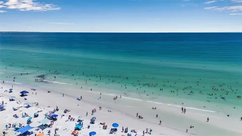 a kitchen with stainless steel appliances kitchen island granite countertop a stove a sink and a microwave