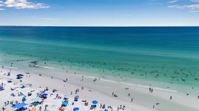 a kitchen with stainless steel appliances kitchen island granite countertop a stove a sink and a microwave