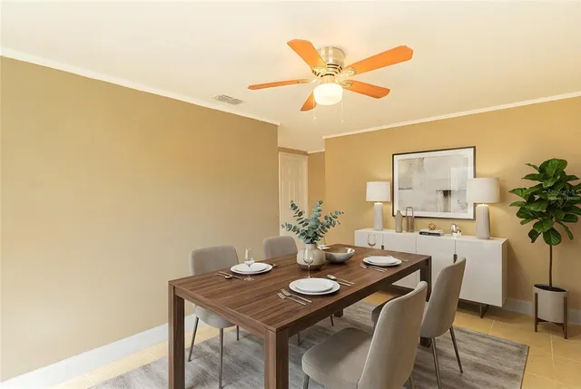 a view of a dining room with furniture and a potted plant