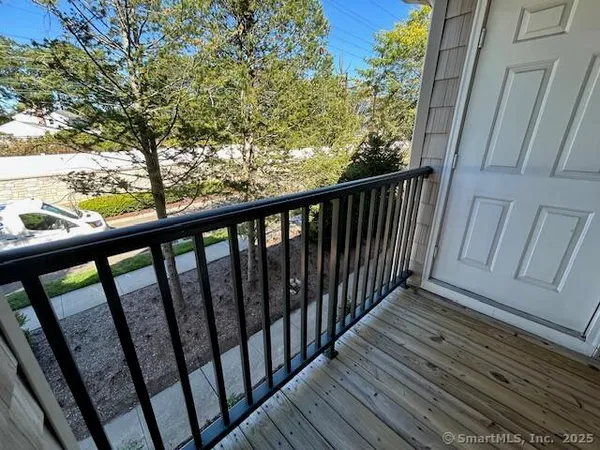 a view of balcony with wooden floor