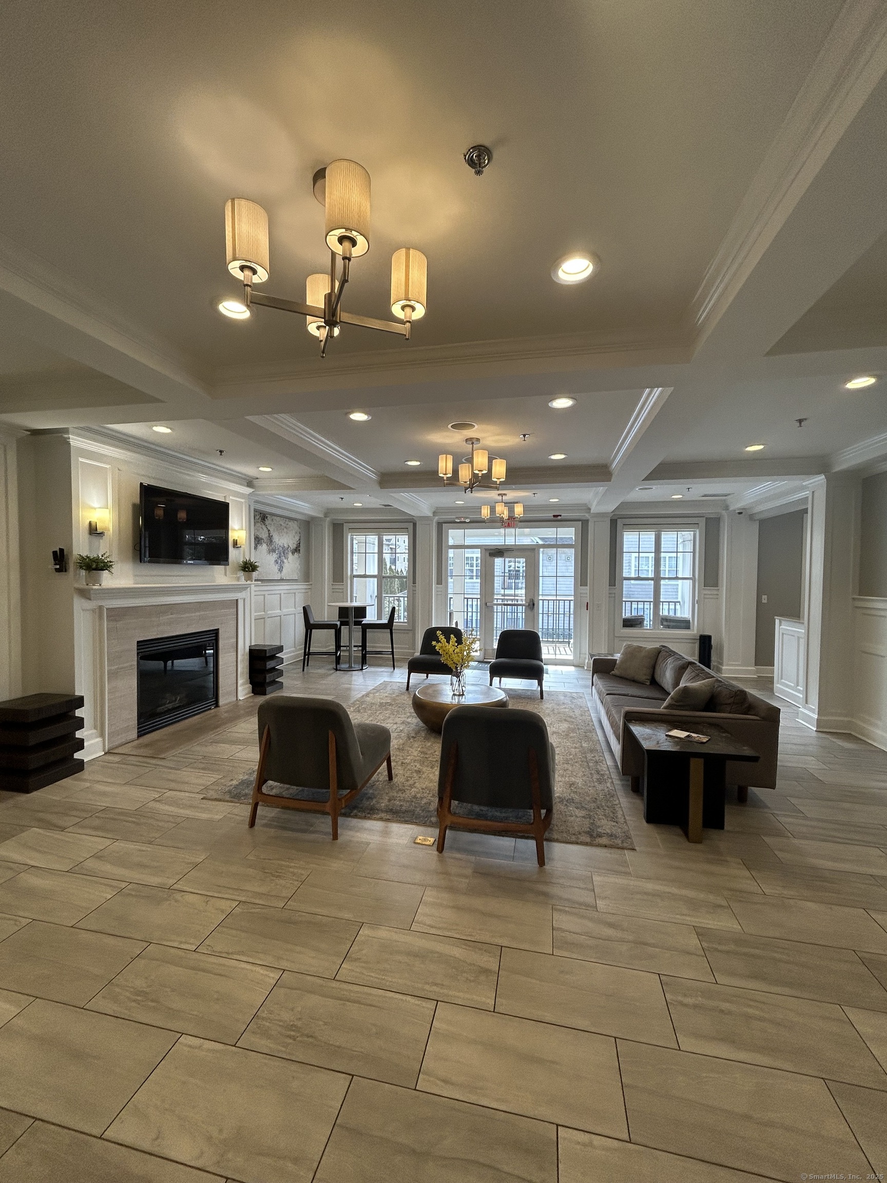 138 Hollow Tree Ridge Road, Unit 1523 Darien, CT 06820 - Photo 8 of 26 a living room with furniture and a fireplace