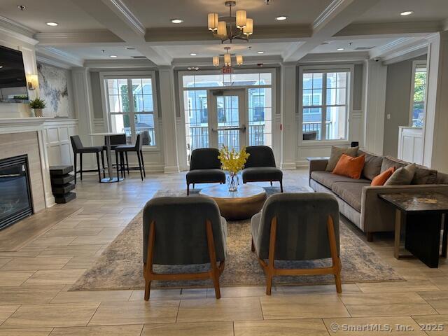 138 Hollow Tree Ridge Road, Unit 1523 Darien, CT 06820 - Photo 10 of 26 a living room with fireplace furniture and a flat screen tv