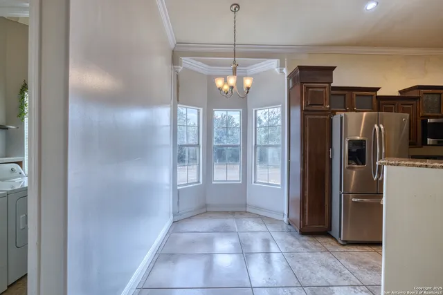 a view of a kitchen with a refrigerator and microwave