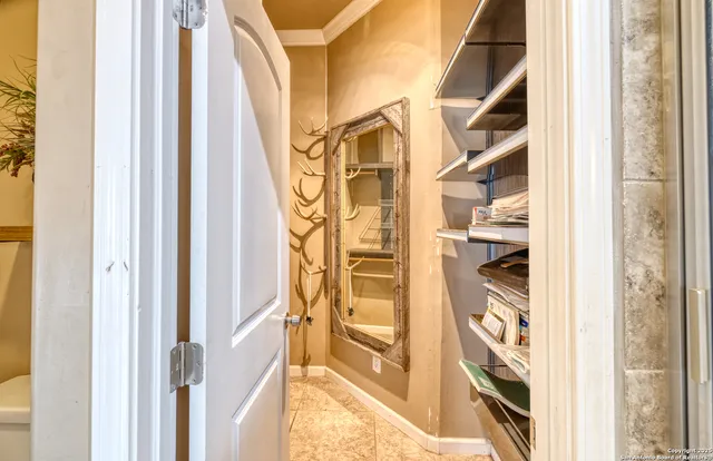 a bathroom with a granite countertop double vanity sink and a mirror