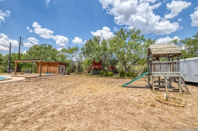 a view of a swimming pool with a yard