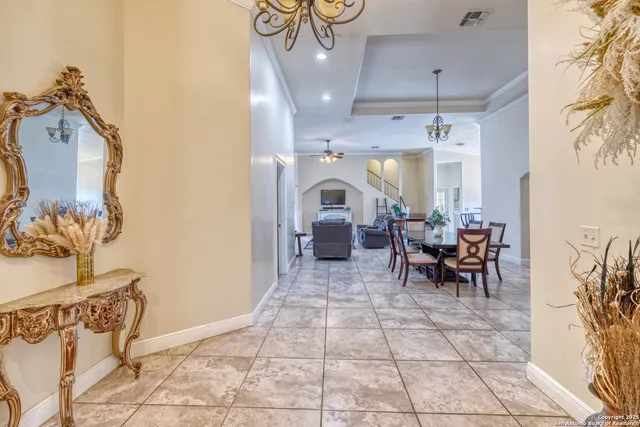 a view of a dining room with furniture and a chandelier