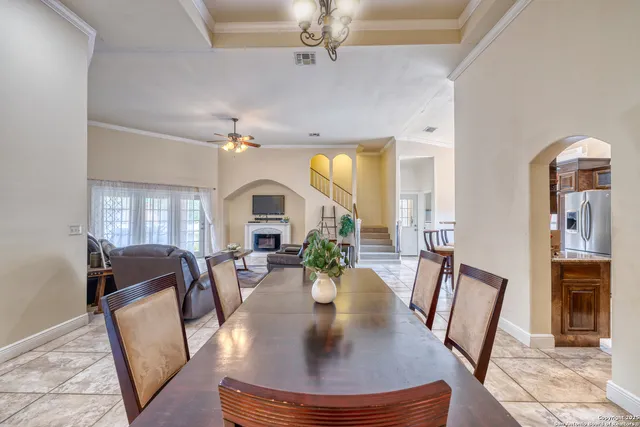 a view of a dining room with furniture a chandelier and wooden floor