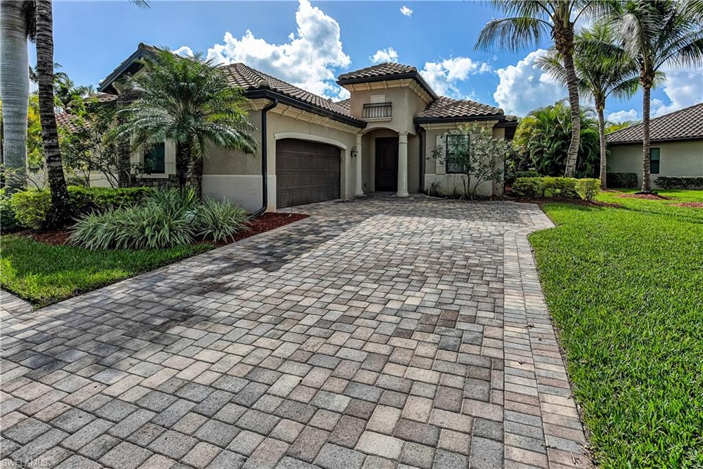 9215 Veneto Lane Naples, FL 34113 - Photo 1 of 34 a front view of a house with a garden