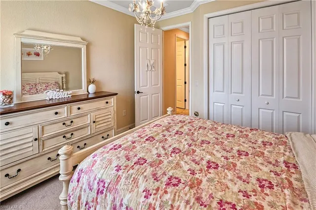 a bedroom with a large bed and a mirror on dresser