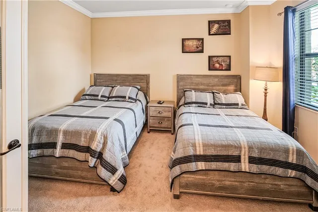 a bedroom with two beds and a window