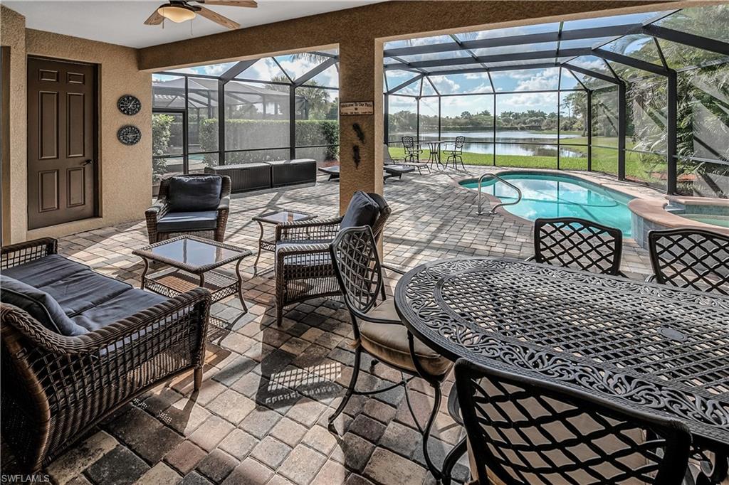 9215 Veneto Lane Naples, FL 34113 - Photo 16 of 34 a living room with furniture and a floor to ceiling window