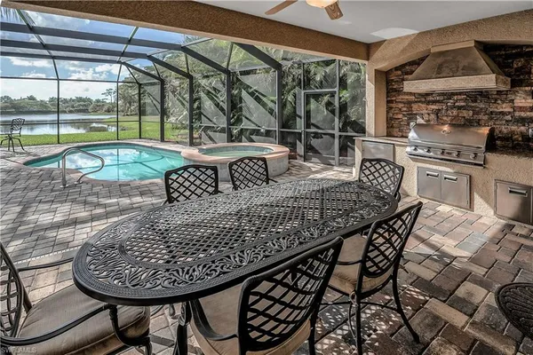 a roof deck with a dining table and chairs with wooden floor