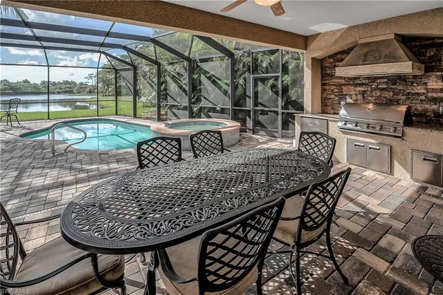 a roof deck with a dining table and chairs with wooden floor