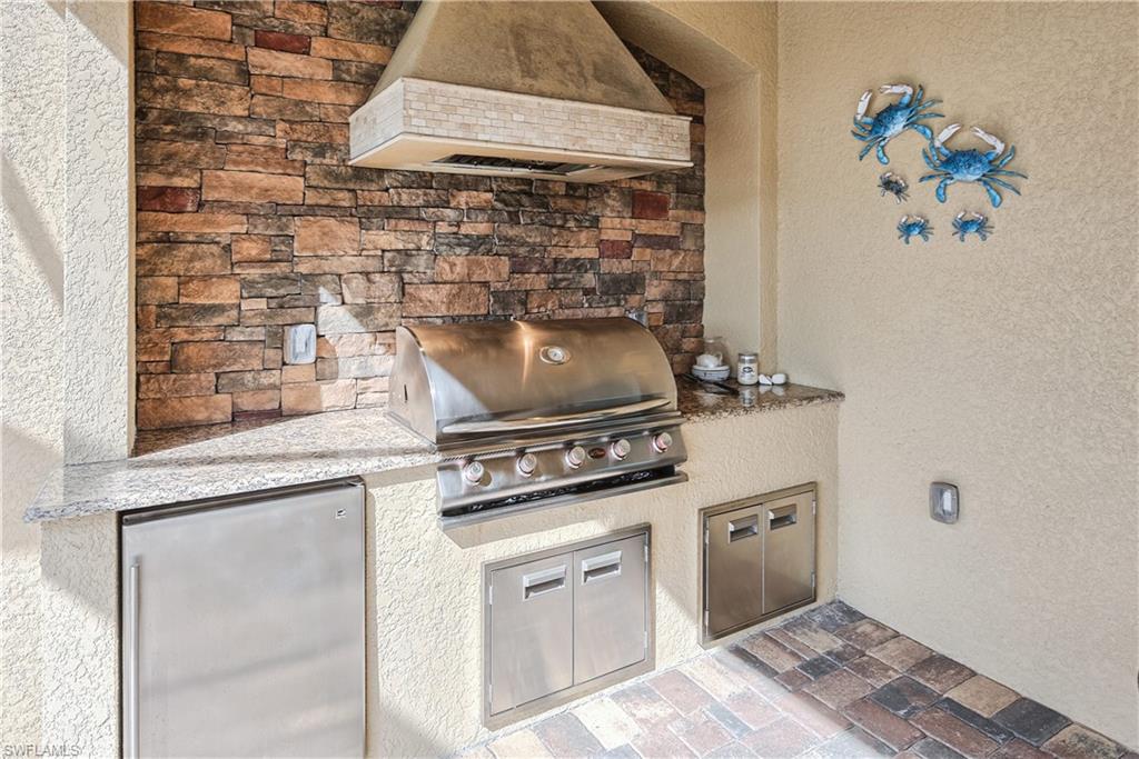9215 Veneto Lane Naples, FL 34113 - Photo 21 of 34 a stove top oven sitting inside of a kitchen