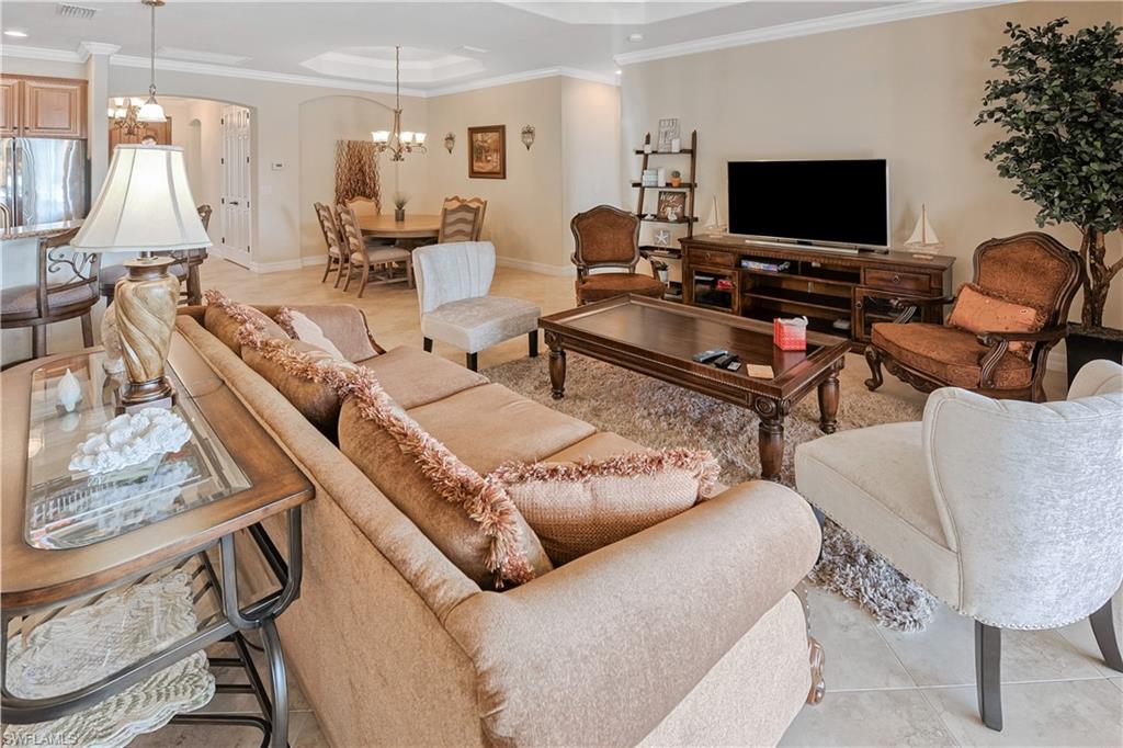 9215 Veneto Lane Naples, FL 34113 - Photo 3 of 34 a living room with furniture and a flat screen tv