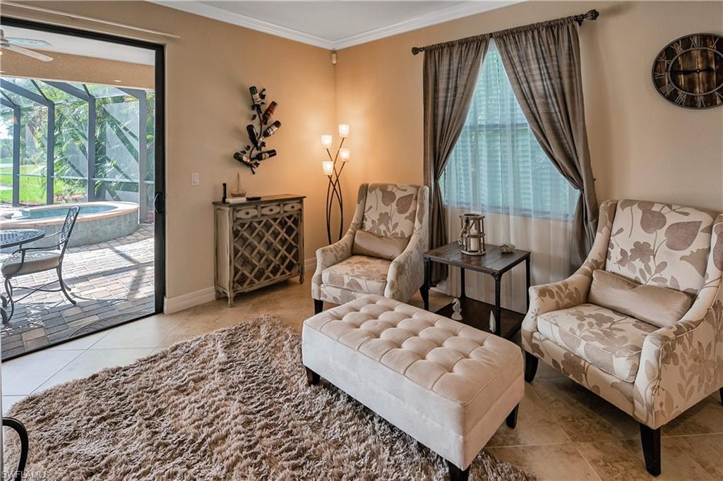 9215 Veneto Lane Naples, FL 34113 - Photo 4 of 34 a living room with furniture and a window
