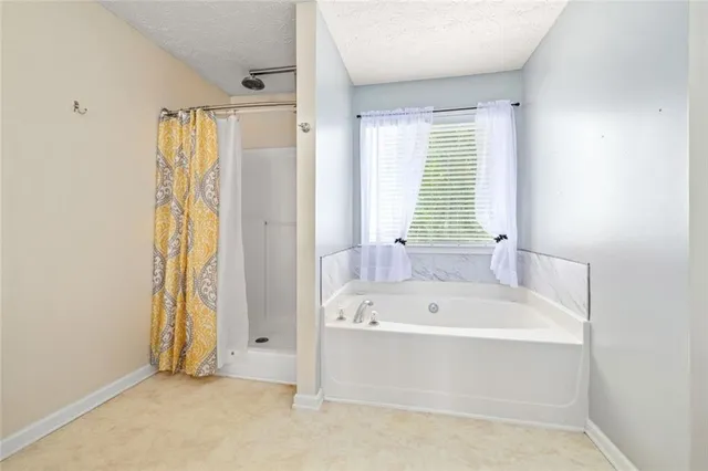 a bathroom with a bathtub and a shower