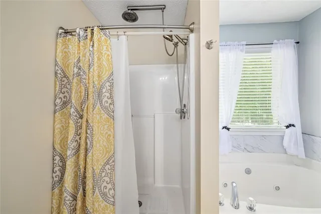 a bathroom with a sink a mirror and a shower