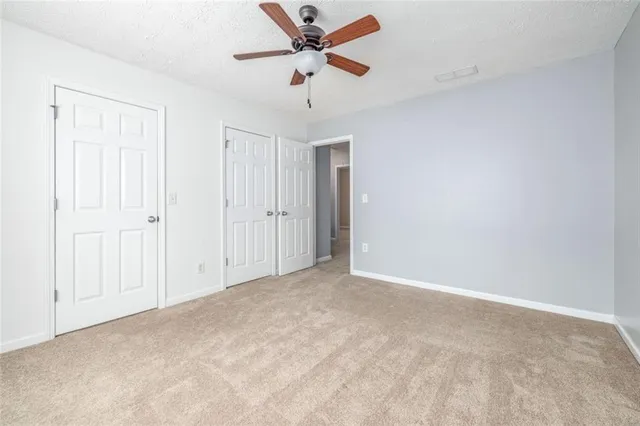 a view of a patio with table and chairs potted plants and large tree