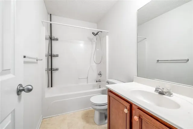 a view of a field with trees in the background