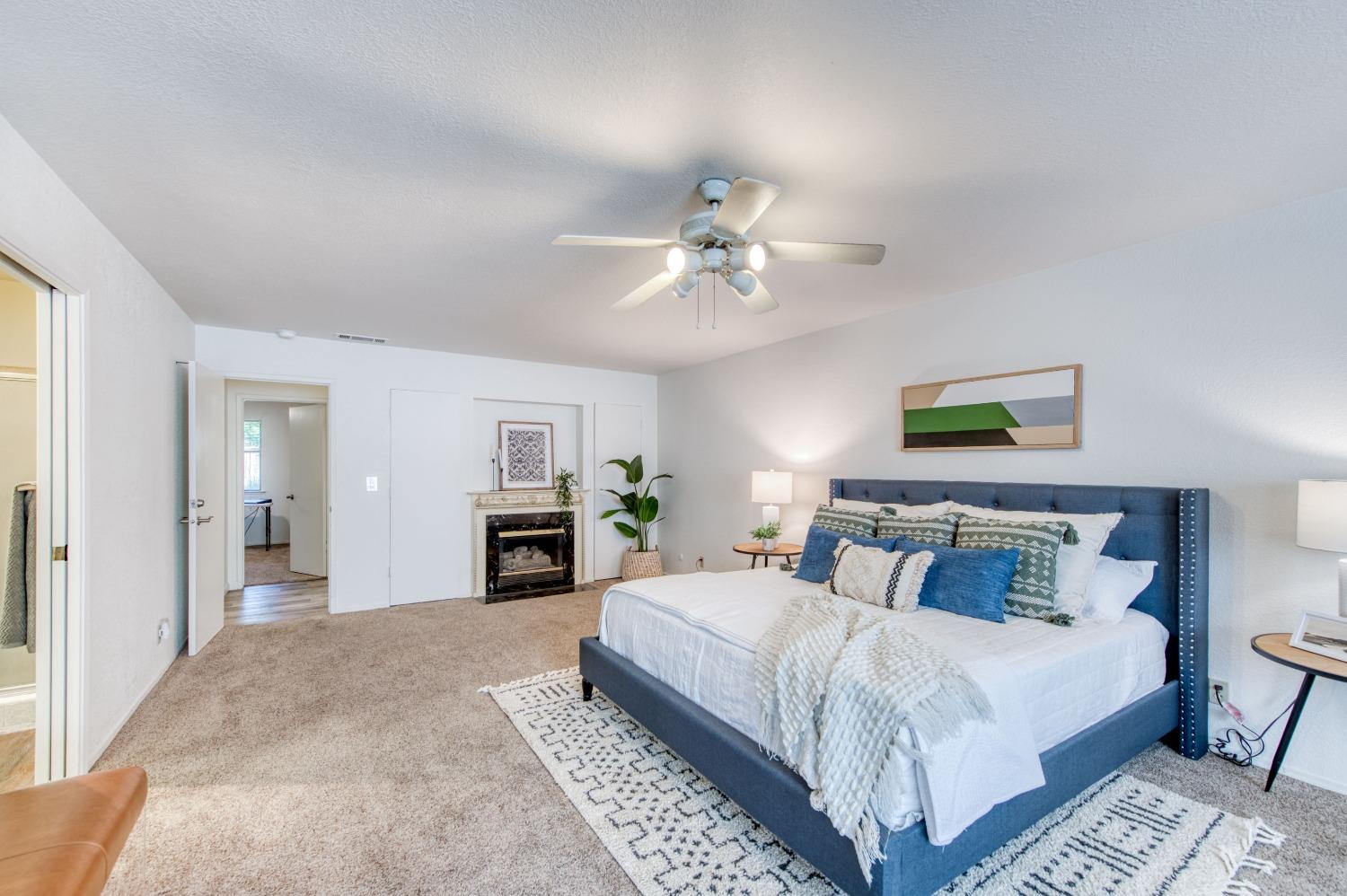 133 North Cindy Avenue Clovis, CA 93612 - Photo 11 of 19 a bedroom with a large bed and a chandelier