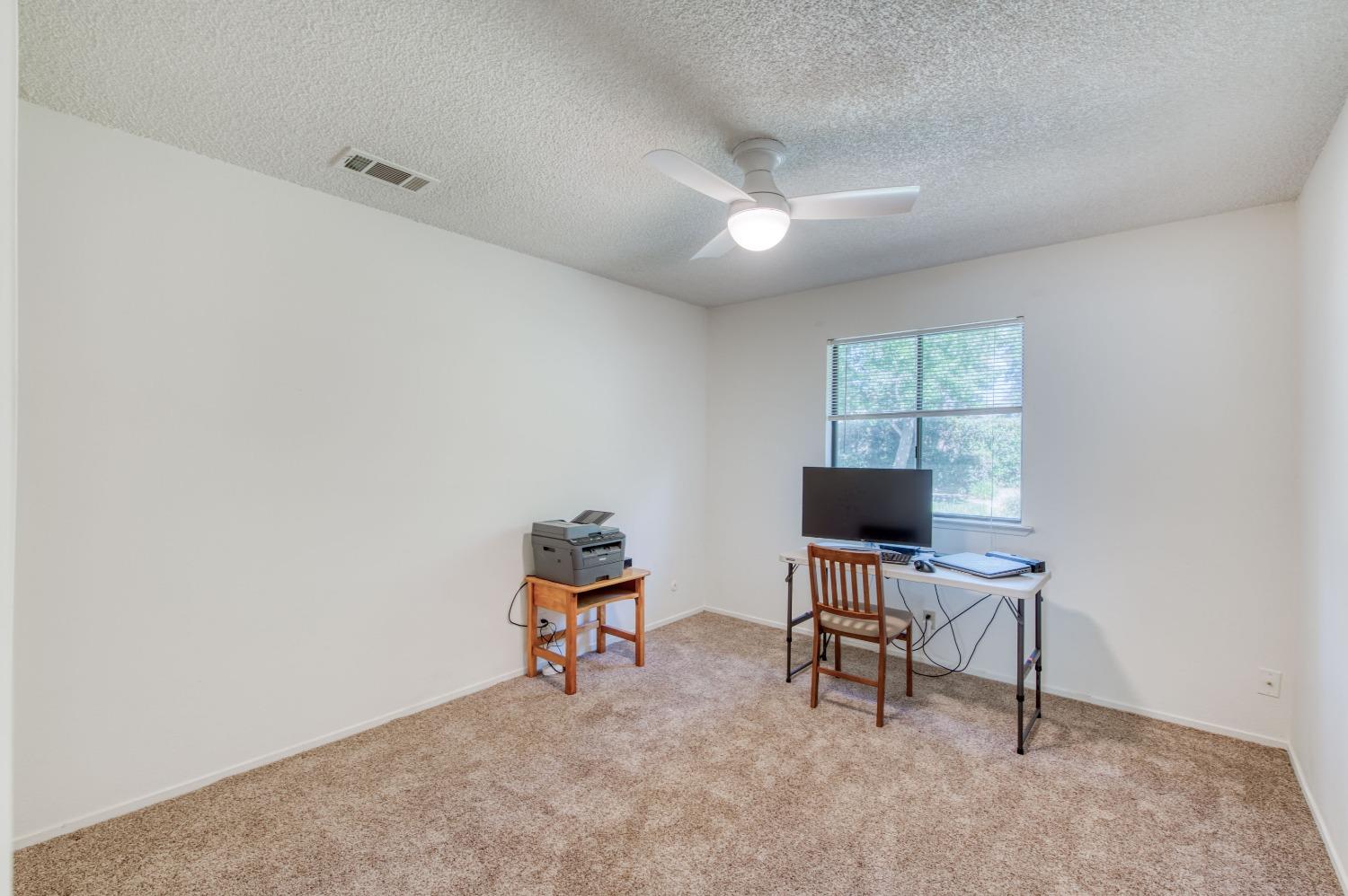 133 North Cindy Avenue Clovis, CA 93612 - Photo 17 of 19 a view of a workspace with furniture and a window