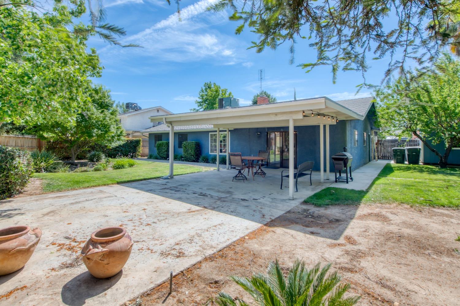 133 North Cindy Avenue Clovis, CA 93612 - Photo 18 of 19 a view of a chair and table in backyard of the house