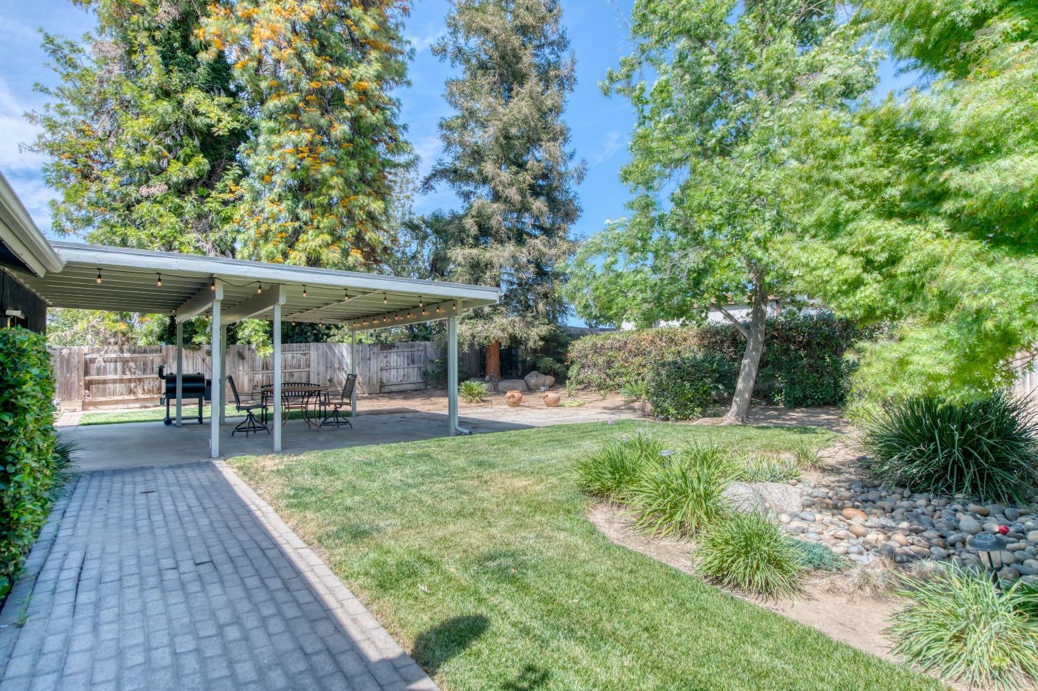 133 North Cindy Avenue Clovis, CA 93612 - Photo 19 of 19 a view of a patio with table and chairs under an umbrella