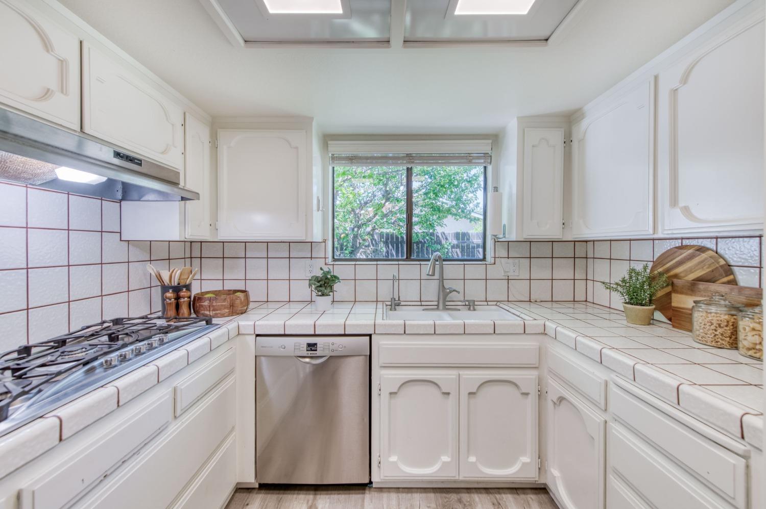 133 North Cindy Avenue Clovis, CA 93612 - Photo 4 of 19 a kitchen with white cabinets and white appliances