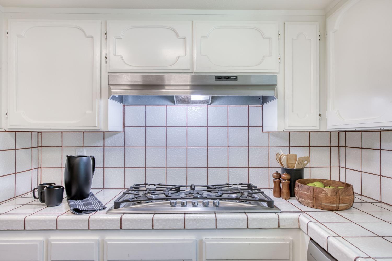 133 North Cindy Avenue Clovis, CA 93612 - Photo 5 of 19 a kitchen with a stove and cabinets